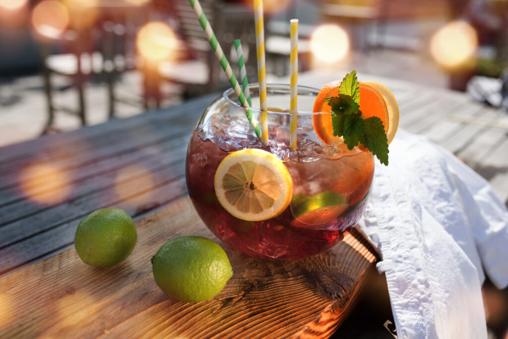 Sangria or punch with fruit on a wooden table in a restaurant and bokeh